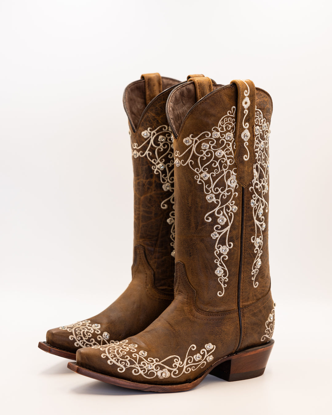 Western wear for women, cowgirl outfits, southern style clothing, fringe jacket, denim snap shirt, western dress, pearl snap shirt, high-waisted jeans, ranch wear, boho cowgirl style, leather cowboy boots, embroidered boots, square toe boots, ankle cowboy boots, cowgirl hat, western belt, fringe purse, turquoise jewelry, bandana, concho belt, boot accessories, cow print fashion, rodeo handbag, rustic necklace, Nashville fashion, rodeo ready, country girl style, Cowhide, Cow boots, Leather boots