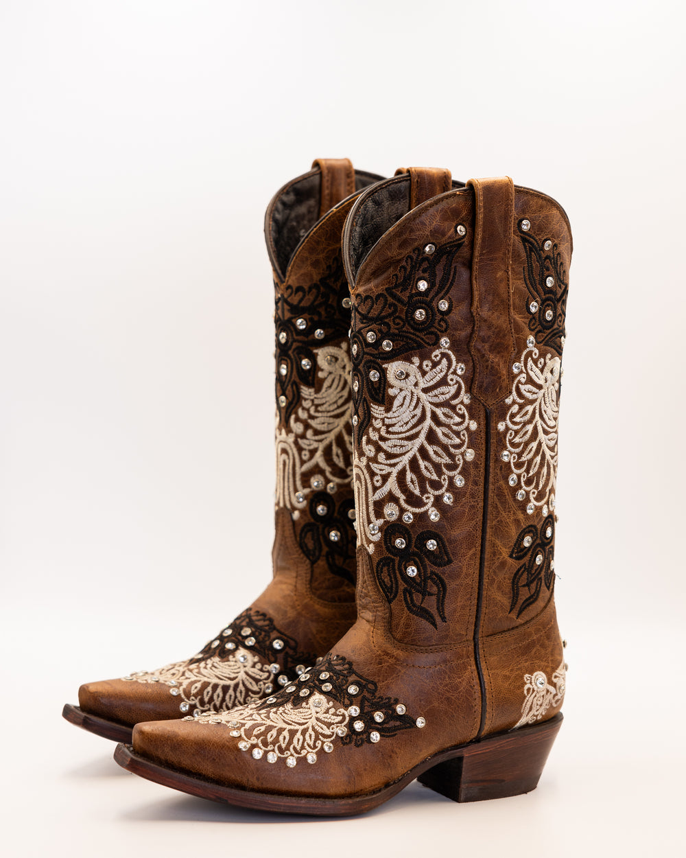 Western wear for women, cowgirl outfits, southern style clothing, fringe jacket, denim snap shirt, western dress, pearl snap shirt, high-waisted jeans, ranch wear, boho cowgirl style, leather cowboy boots, embroidered boots, square toe boots, ankle cowboy boots, cowgirl hat, western belt, fringe purse, turquoise jewelry, bandana, concho belt, boot accessories, cow print fashion, rodeo handbag, rustic necklace, Nashville fashion, rodeo ready, country girl style, Cowhide, Cow boots, Leather boots